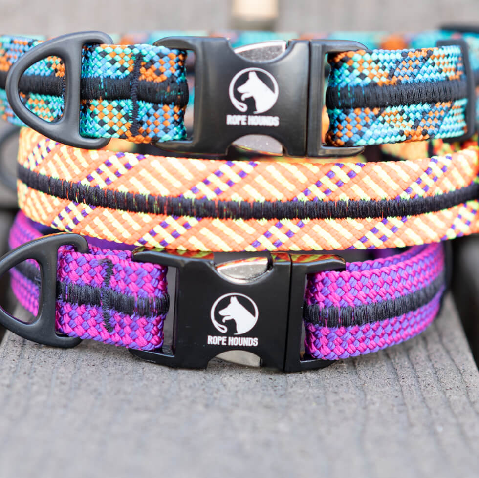 Stack of three colorful Rope Hounds collars in teal, orange, and pink/purple.